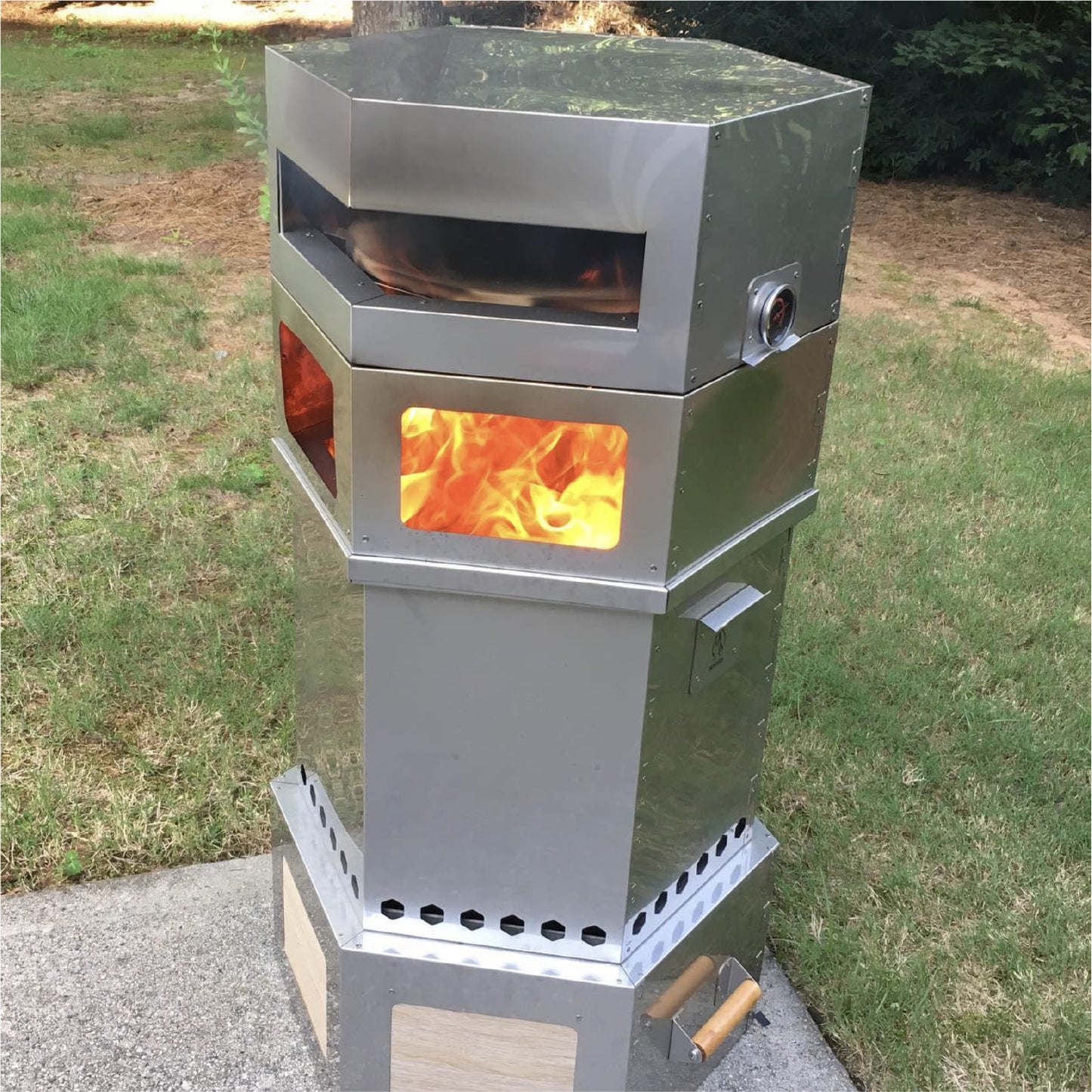 Hot Ash Rambler 3-in-1 with smokeless fire pit and pizza oven burning outdoors