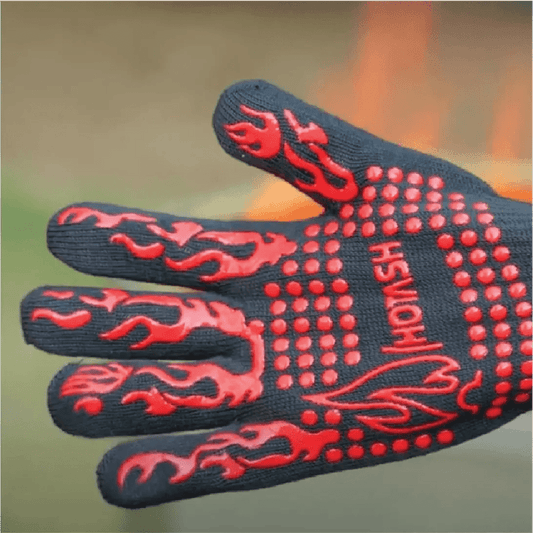 A durable black BBQ glove with vibrant red non-slip dots and flame accents, designed for handling high heat.