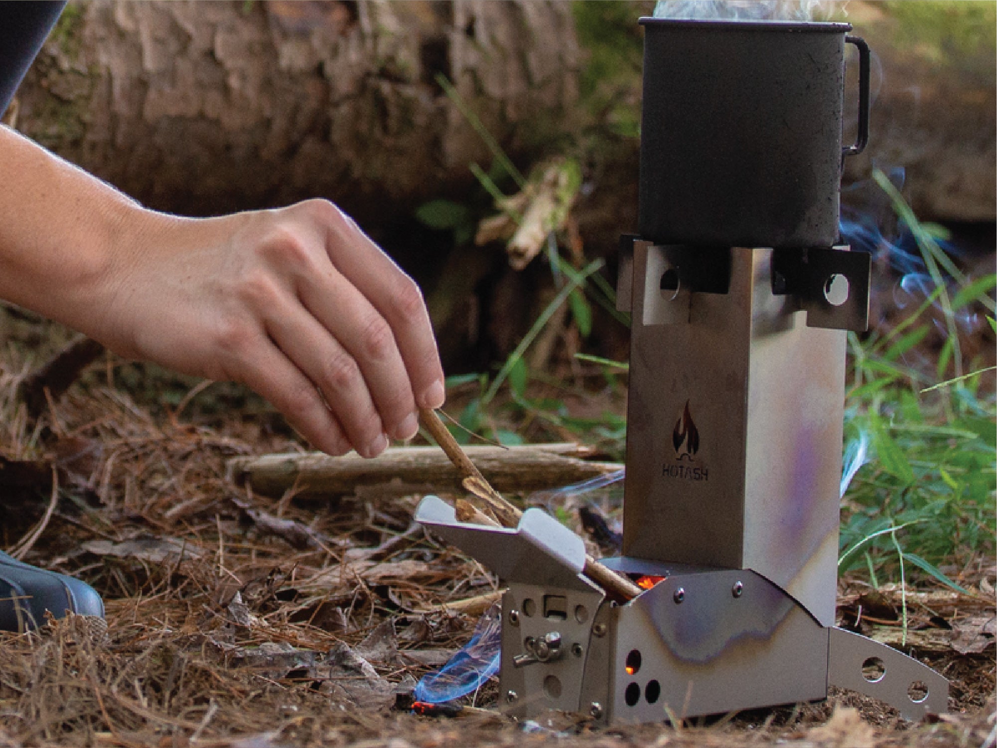 Inserting fuel into the bottom of the Hot Ash Stove combustion chamber