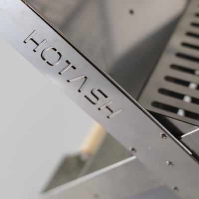 Detail image showing the Hot Ash Stove logo engraved on Atlas X Portable Charcoal Grill